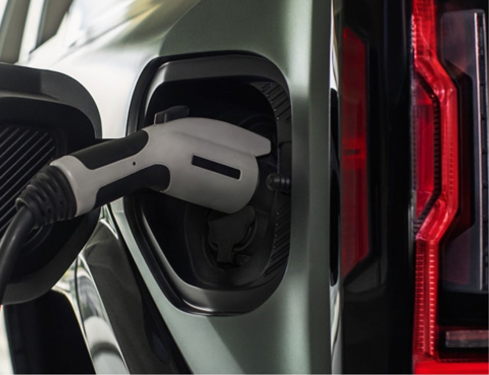 Close up of charging port with charger plugged in on a GMC Hummer EV SUV - Lasseter Motor Company GMC in Moultrie GA